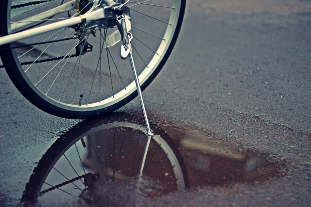 濡れている地面に自転車が停まっているところ
